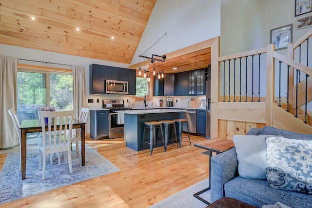 interior space featuring light wood-style floors, high vaulted ceiling, stairs, recessed lighting, and wood ceiling