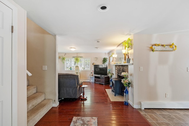living room with stairway, baseboards, a baseboard radiator, and wood-type flooring