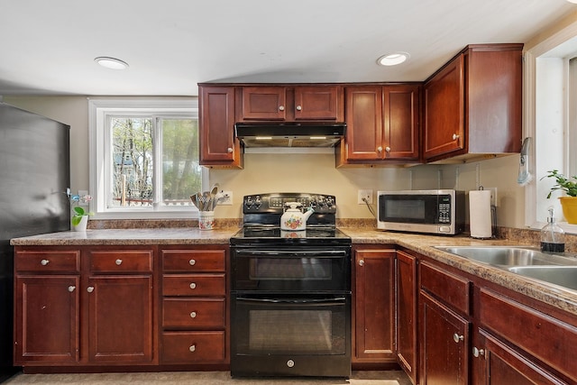 kitchen featuring range with two ovens, dark brown cabinets, stainless steel microwave, under cabinet range hood, and recessed lighting