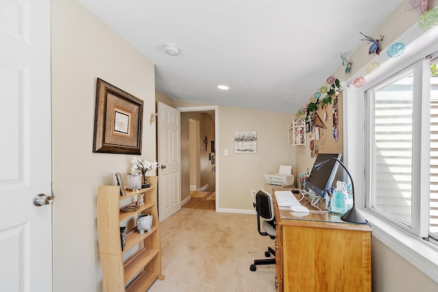 office space with baseboards and light carpet