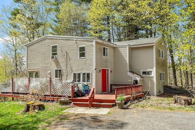 rear view of house featuring a deck