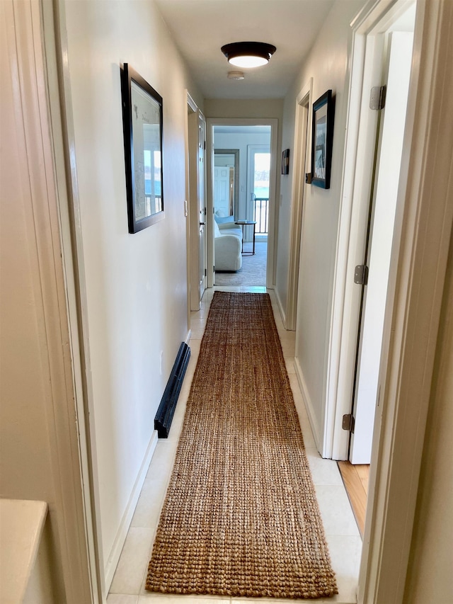 corridor featuring baseboards and visible vents