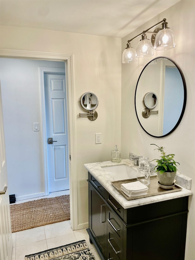 bathroom featuring tile patterned floors, baseboards, and vanity