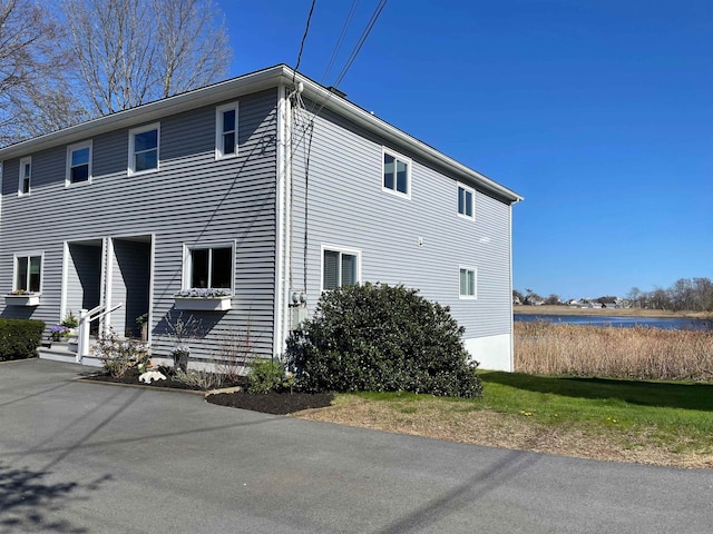 view of side of home with a water view