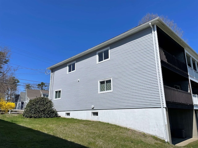 view of home's exterior featuring a lawn and crawl space