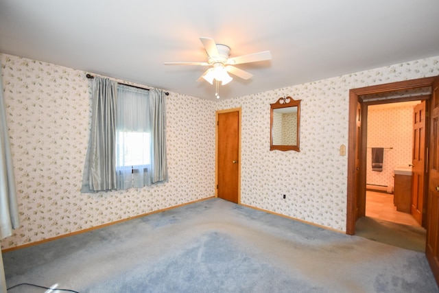 unfurnished bedroom featuring carpet flooring, wallpapered walls, baseboards, and baseboard heating