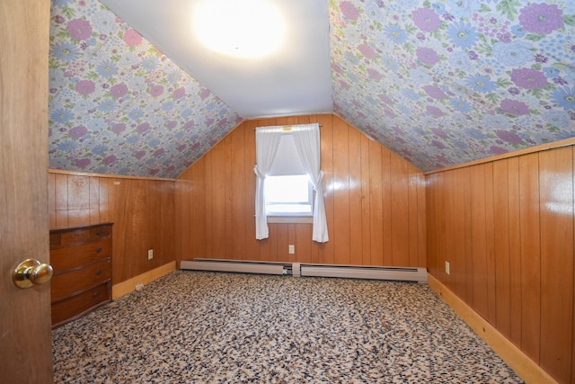 bonus room featuring wooden walls, a baseboard radiator, carpet, and vaulted ceiling
