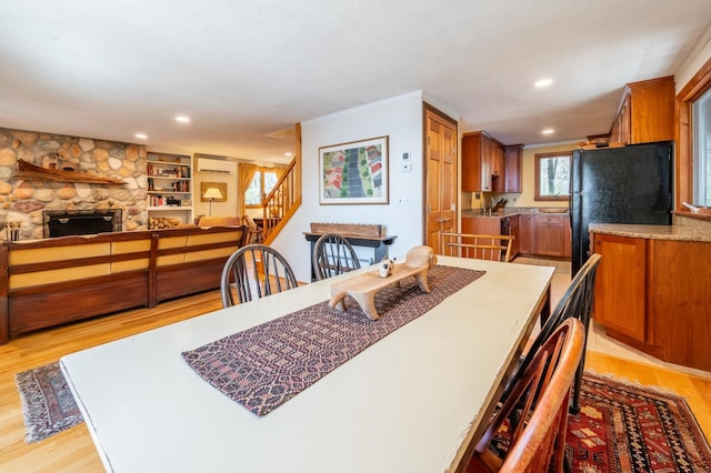 dining space with light wood-style floors, recessed lighting, stairs, and a wall mounted air conditioner