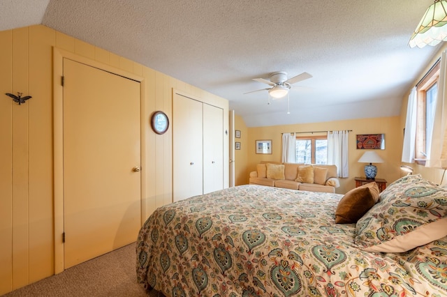 carpeted bedroom with a ceiling fan, a textured ceiling, and lofted ceiling