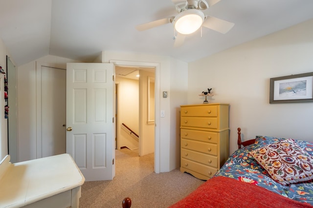 bedroom featuring a ceiling fan, lofted ceiling, and light colored carpet