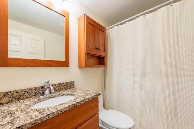 bathroom with vanity, toilet, and a shower with curtain