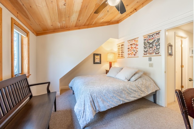 carpeted bedroom featuring a ceiling fan and wood ceiling
