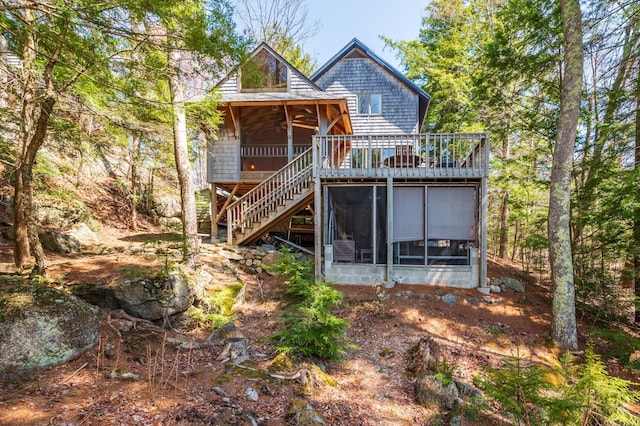 rear view of house featuring a deck, a ceiling fan, stairs, and a sunroom