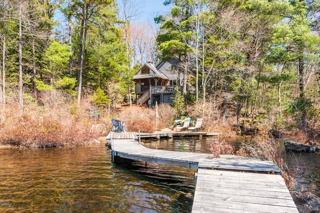 dock area with stairway and a water view