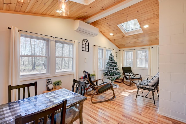 living area with vaulted ceiling with skylight, wood ceiling, a wall unit AC, light wood finished floors, and recessed lighting