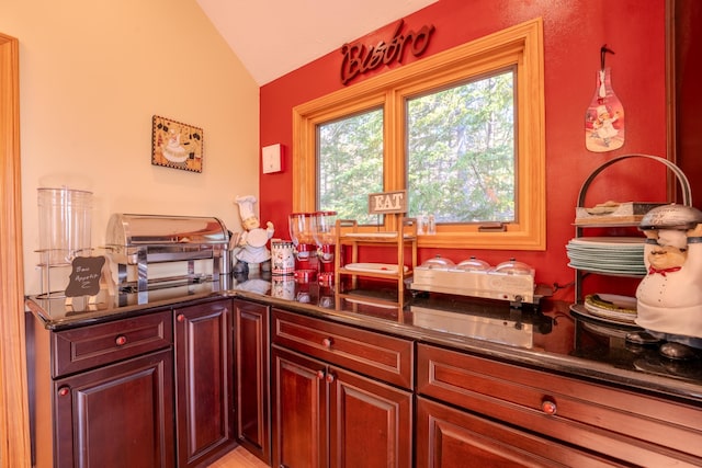 interior space featuring dark countertops and lofted ceiling