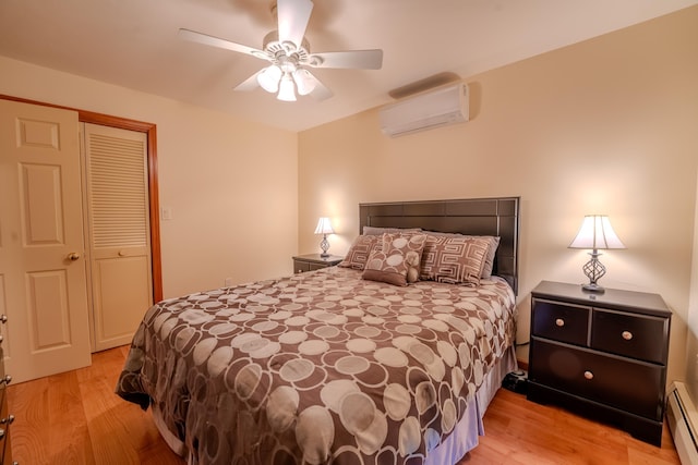 bedroom featuring light wood-type flooring, a wall mounted air conditioner, ceiling fan, and baseboard heating