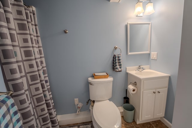 full bath featuring tile patterned flooring, curtained shower, vanity, baseboards, and toilet