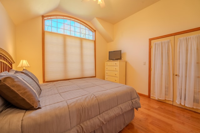 bedroom with a ceiling fan, light wood finished floors, and lofted ceiling