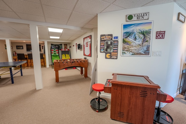 rec room featuring baseboards, a drop ceiling, and carpet flooring