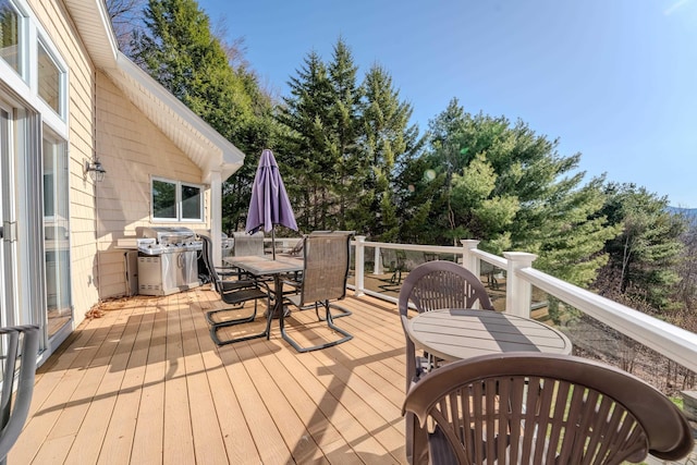 deck featuring grilling area and outdoor dining area