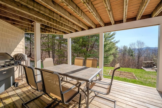 sunroom with a healthy amount of sunlight and outdoor dining area