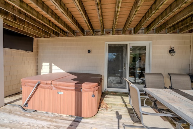 deck featuring a hot tub and outdoor dining space