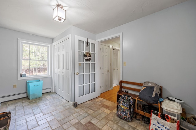 interior space with a baseboard radiator and stone finish flooring