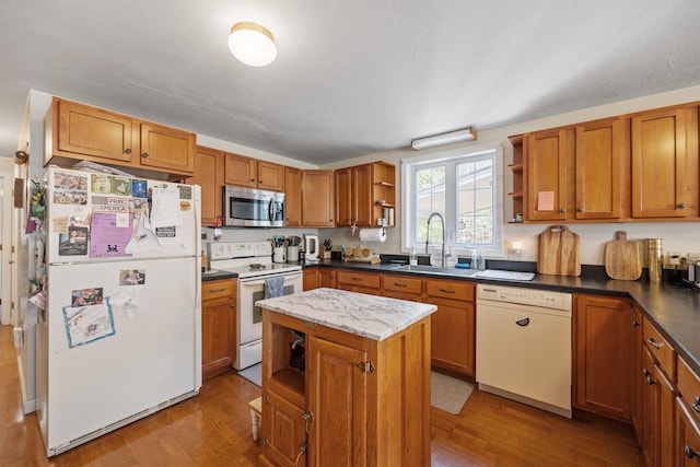 kitchen with light wood-style floors, open shelves, a sink, and white appliances