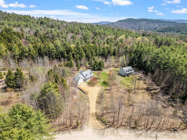 drone / aerial view featuring a mountain view and a wooded view
