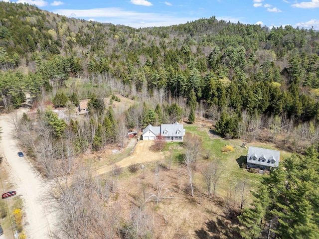 birds eye view of property with a forest view