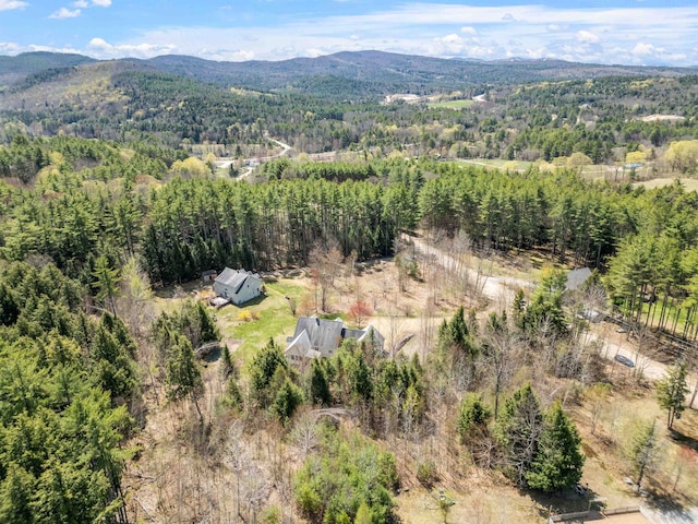 drone / aerial view with a mountain view and a forest view