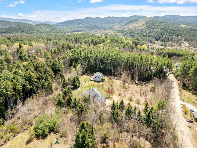 birds eye view of property with a mountain view and a wooded view