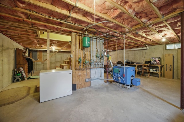 unfinished below grade area featuring a heating unit, heating fuel, stairs, white fridge, and electric panel