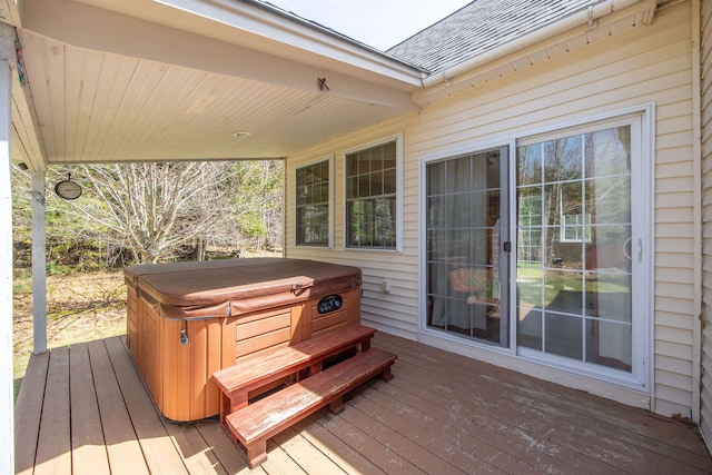 wooden deck with a hot tub