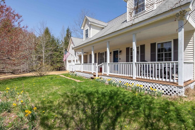 view of side of home featuring a porch, a shingled roof, and a lawn