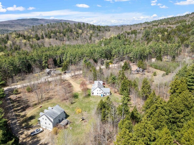 aerial view featuring a view of trees and a mountain view