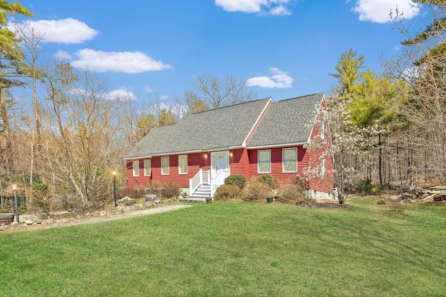 view of front of property with roof with shingles and a front lawn
