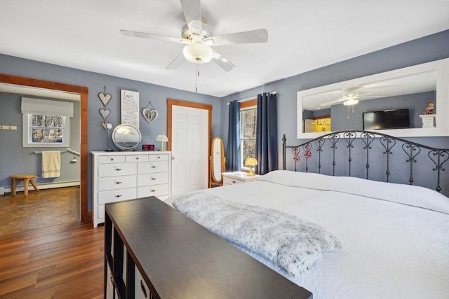 bedroom with baseboard heating, a ceiling fan, and dark wood finished floors