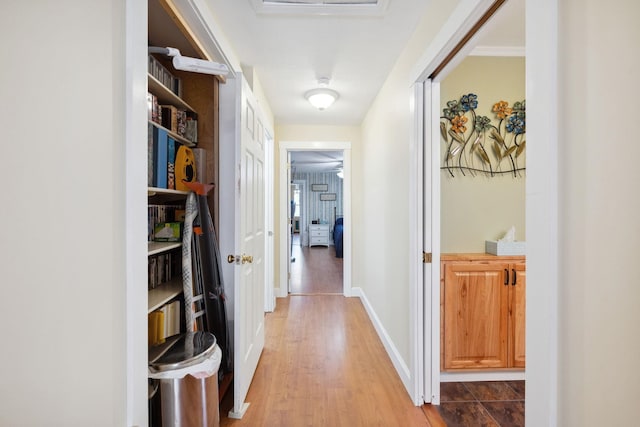 hall featuring baseboards and wood finished floors