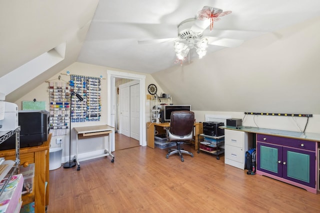office space featuring a ceiling fan, wood finished floors, and vaulted ceiling