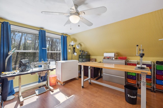office space with washer / clothes dryer, a ceiling fan, and wood finished floors