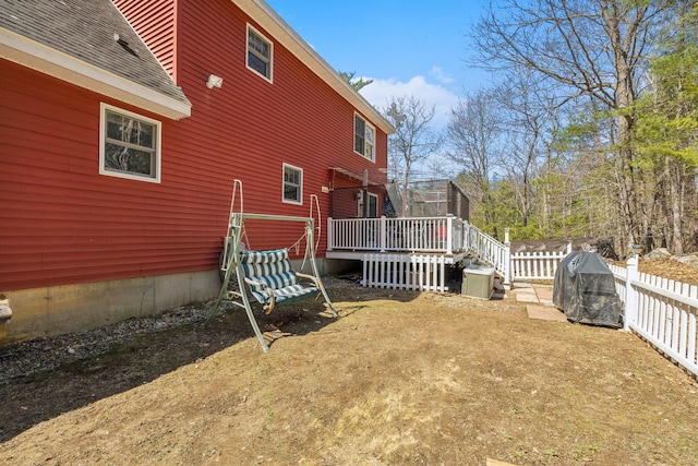 exterior space featuring a fenced backyard and a wooden deck