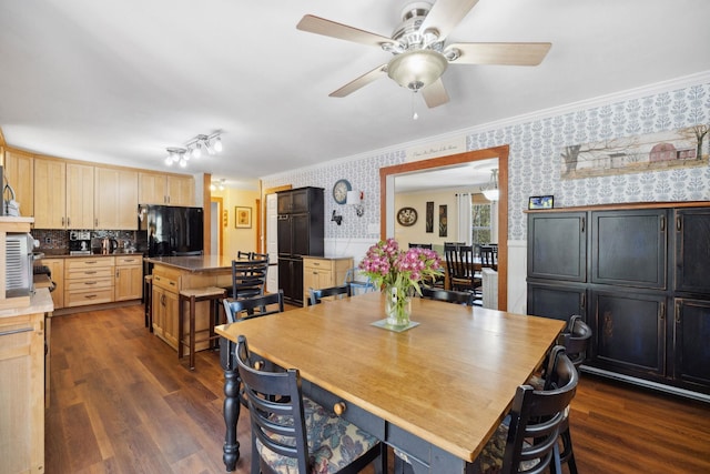dining room with dark wood-type flooring, a ceiling fan, ornamental molding, and wallpapered walls