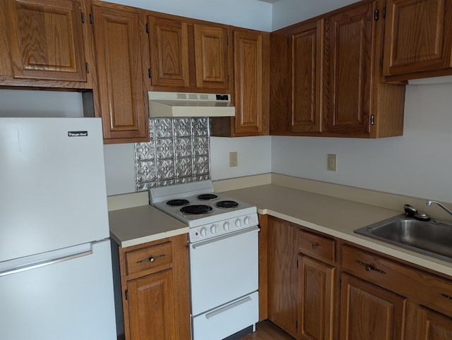 264 Main St Unit Q 31, Lincoln, NH 03251 - kitchen featuring brown cabinetry, white appliances, light countertops, under cabinet range hood, and a sink