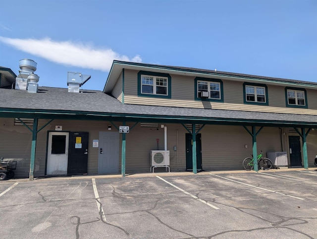 264 Main St Unit Q 31, Lincoln, NH 03251 - view of front facade featuring a porch, ac unit, and uncovered parking