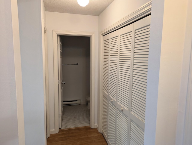 264 Main St Unit Q 31, Lincoln, NH 03251 - hall with a textured ceiling, wood finished floors, and a baseboard radiator