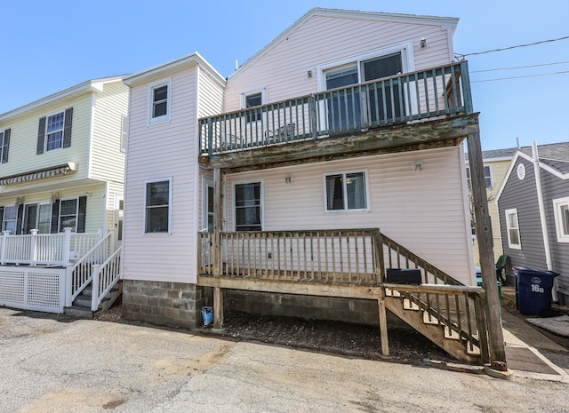 back of property featuring a balcony