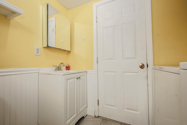 bathroom featuring wainscoting and a sink