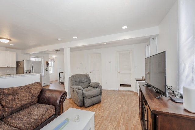 living room featuring recessed lighting, light wood finished floors, and baseboards